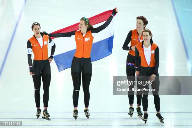 Jorien ter Mors, Marrit Leenstra, Lotte van Beek and Ireen Wust of the Netherlands celebrate winning the gold medal during the Women's Team Pursuit...