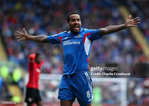 Tom Huddlestone of Hull celebrates after scoring the first goal of the game during the Barclays Premier League match between Cardiff City and Hull...