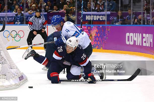 Ossi Vaananen of Finland collides with Paul Stastny of the United States in the first period during the Men's Ice Hockey Bronze Medal Game on Day 15...