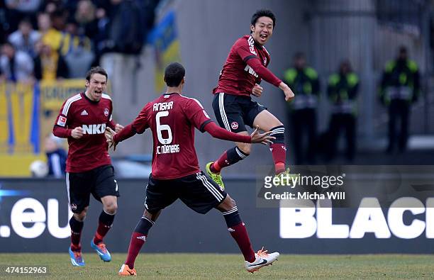 Hiroshi Kiyotake of Nuernberg celebrates with team-mates after scoring his team's first goal during the Bundesliga match between 1. FC Nuernberg and...