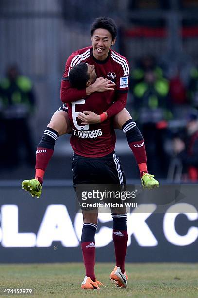Hiroshi Kiyotake of Nuernberg celebrates with team-mate Martin Angha of Nuernberg after scoring his team's first goal during the Bundesliga match...