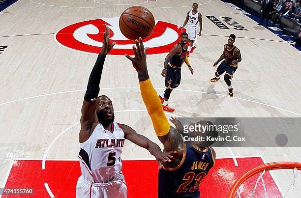 DeMarre Carroll of the Atlanta Hawks shoots against LeBron James of the Cleveland Cavaliers in the first half during Game One of the Eastern...