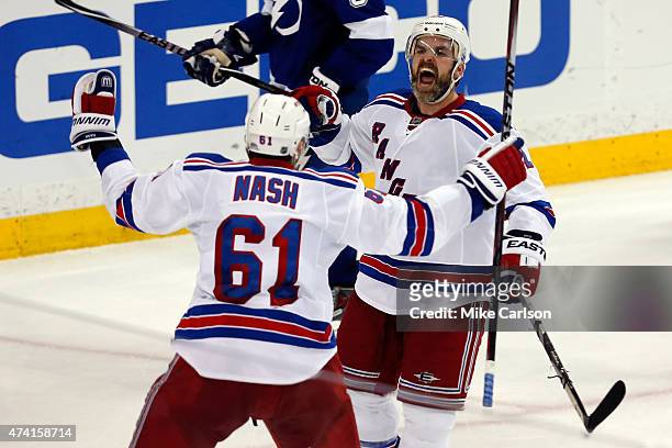 Dan Boyle of the New York Rangers celebrates with teammate Rick Nash after scoring a goal to tie the game up late in the third period against Ben...