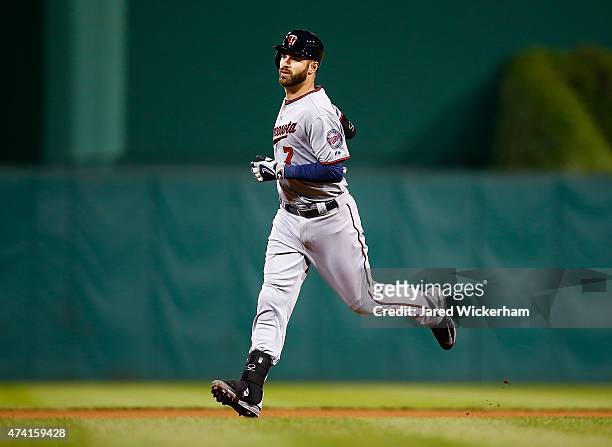 Joe Mauer of the Minnesota Twins trots around the bases after hitting the game-winning solo home run in the 13th inning against the Pittsburgh...