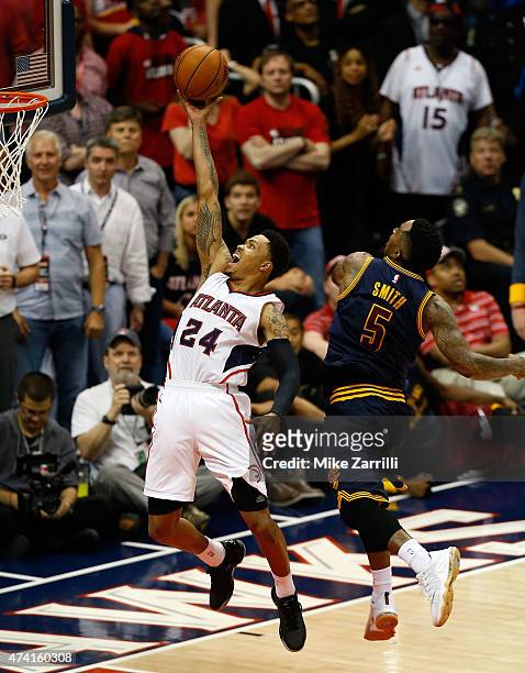 Guard Kent Bazemore of the Atlanta Hawks shoots behind guard J.R. Smith of the Cleveland Cavaliers during Game One of the Eastern Conference Finals...