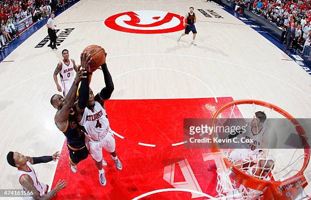 Paul Millsap of the Atlanta Hawks rebounds against LeBron James of the Cleveland Cavaliers in the second half during Game One of the Eastern...