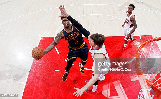 Iman Shumpert of the Cleveland Cavaliers shoots against Kyle Korver of the Atlanta Hawks in the second half during Game One of the Eastern Conference...