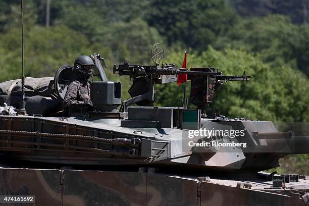 South Korean soldier of the 8th Mechanized Infantry Division looks on from the turret of a battle tank during a live-fire exercise near the...