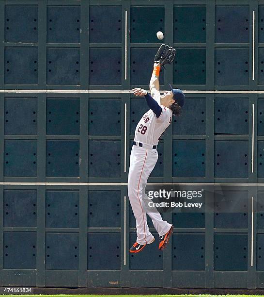 Colby Rasmus of the Houston Astros leaps a the wall but can't make the catch on a fly ball by Brett Lawrie of the Oakland Athletics in the eighth...