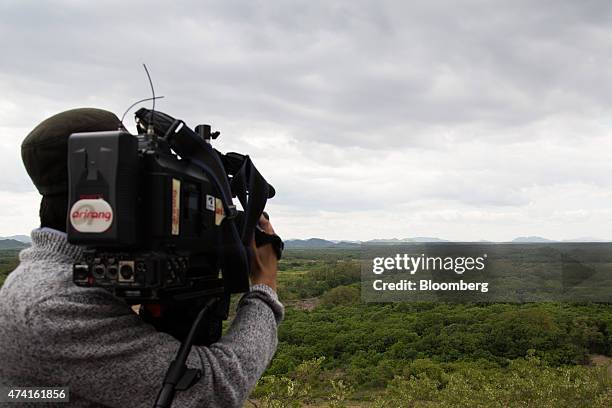 Camera operator shoots the demilitarized zone , front, and North Korea's Propaganda village from the Cheorwon Peace Observatory in Cheorwon, South...