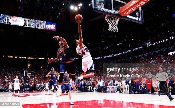 Kent Bazemore of the Atlanta Hawks shoots against J.R. Smith of the Cleveland Cavaliers in the second half during Game One of the Eastern Conference...