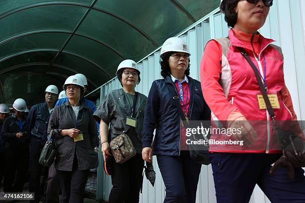 Visitors wearing helmets enter the Second Tunnel, an "infiltration" tunnel dug by North Korea, near the demilitarized zone in Cheorwon, South Korea,...