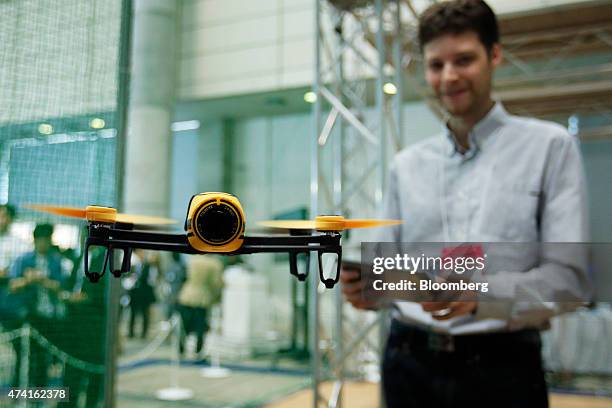 The Parrot SA Bebop Drone quadcopter hovers in the air as an exhibitor controls it during a demonstration at the International Drone Expo in Chiba,...