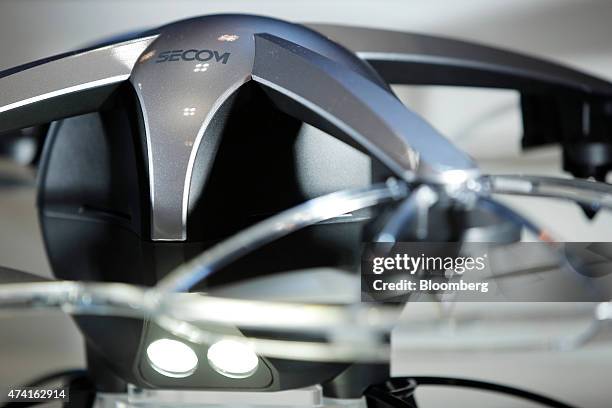 Flying surveillance robot, developed by Secom Co., sits on display at the International Drone Expo in Chiba, Japan, on Wednesday, May 20, 2015. The...