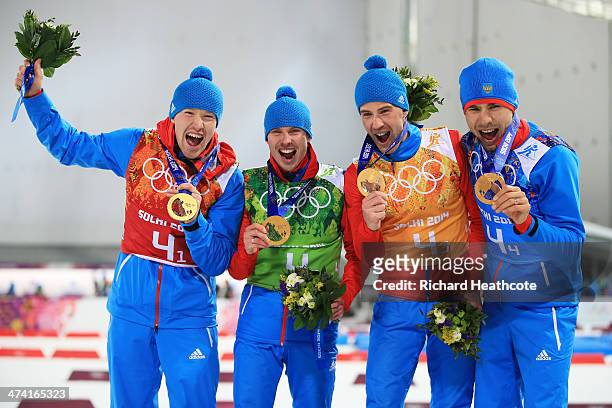 Alexey Volkov, Evgeny Ustyugov, Dmitry Malyshko and Anton Shipulin of Russia celebrate on the podium during flower ceremony for the Men's 4 x 7.5 km...