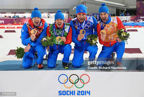 Alexey Volkov, Evgeny Ustyugov, Dmitry Malyshko and Anton Shipulin of Russia celebrate on the podium during flower ceremony for the Men's 4 x 7.5 km...