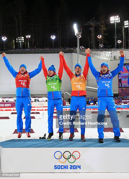 Alexey Volkov, Evgeny Ustyugov, Dmitry Malyshko and Anton Shipulin of Russia celebrate on the podium during the medal ceremony for the Men's 4 x 7.5...