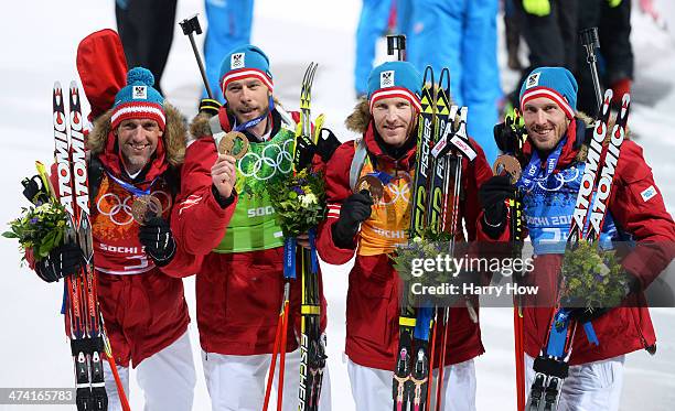 Bronze medalists Christoph Sumann, Daniel Mesotitsch, Simon Eder and Dominik Landertinger of Austria celebrate after the medal ceremony for the Men's...