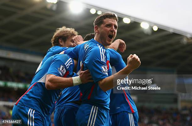 Alex Bruce of Hull City and teammates mob Jake Livermore after he scores the fourth goal during the Barclays Premier League match between Cardiff...