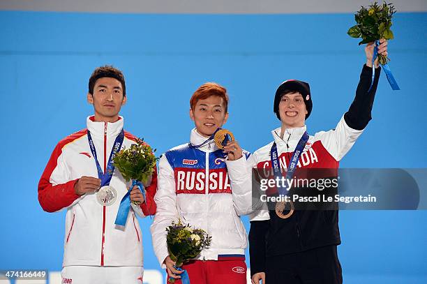 Silver medalist Dajing Wu of China, gold medalist Victor An of Russia and bronze medalist Charle Cournoyer of Canada celebrate on the podium during...