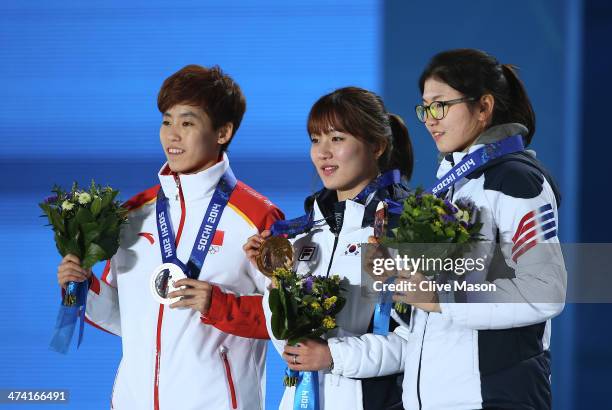 Silver medalist Dajing Wu of China, gold medalist Victor An of Russia and bronze medalist Charle Cournoyer of Canada celebrate on the podium during...