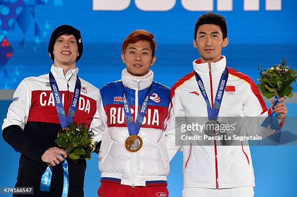 Bronze medalist Charle Cournoyer of Canada, celebrate, gold medalist Victor An of Russia and silver medalist Dajing Wu of China celebrate on the...