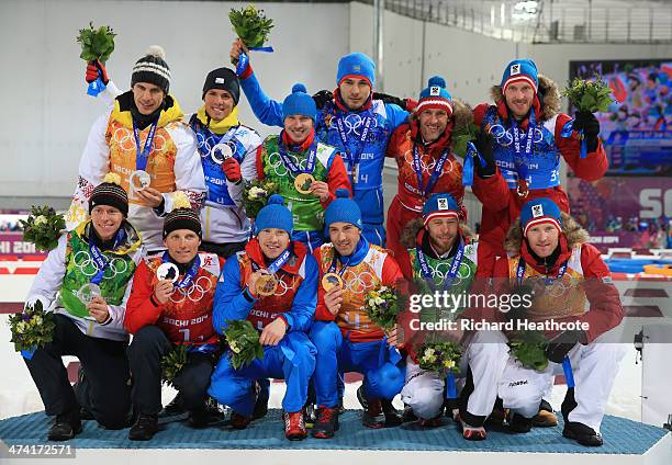 Silver medalists Germany, gold medalists Russia and bronze medalists Austria pose with the medals won during the Men's 4 x 7.5 km Relay during day 15...