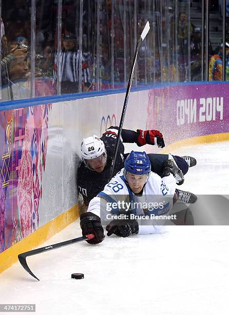 Lauri Korpikoski of Finland goes for the puck against Ryan Suter of the United States in the third period during the Men's Ice Hockey Bronze Medal...