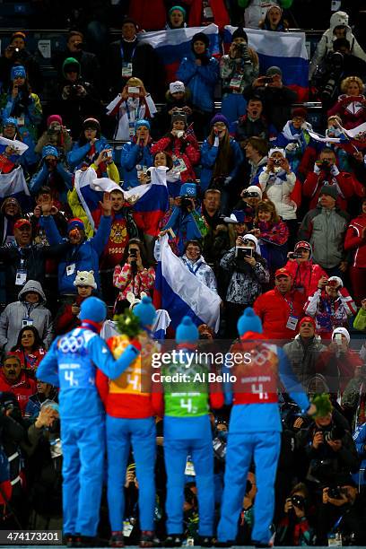 Gold medalists Anton Shipulin, Dmitry Malyshko, Evgeny Ustyugov and Alexey Volkov of Russia celebrate on the podium during the medal ceremony for the...