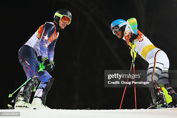 Felix Neureuther of Germany and Ted Ligety of the United States react after both crashing out in the second run during the Men's Slalom during day 15...