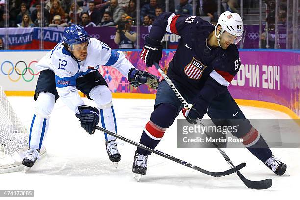 Max Pacioretty of the United States handles the puck against Olli Jokinen of Finland in the third period during the Men's Ice Hockey Bronze Medal...
