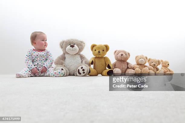 baby sitting in line with teddy bears - babies in a row stock pictures, royalty-free photos & images