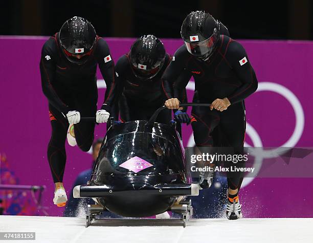 Pilot Hiroshi Suzuki, Toshiki Kuroiwa, Shintaro Sato and Hisashi Miyazaki of Japan team 1 make a run during the Men's Four Man Bobsleigh heats on Day...