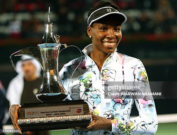 Tennis player Venus Williams poses with her trophy after winning the Dubai Duty Free Tennis Championships on February 22, 2014 in Dubai. Williams won...