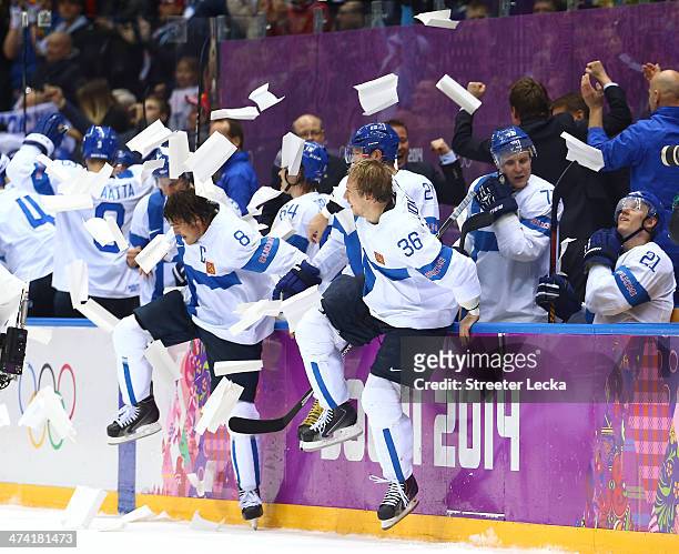 Teemu Selanne and Jussi Jokinen of Finland celebrate with teammates after defeating the United States 5-0 during the Men's Ice Hockey Bronze Medal...