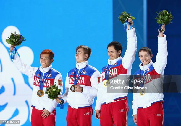 Gold medalists Victor An, Semen Elistratov, Vladimir Grigorev and Ruslan Zakharov of Russia celebrate on the podium during the medal ceremony for the...