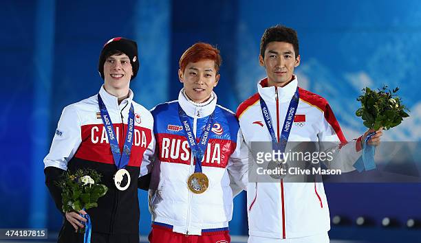 Bronze medalist Charle Cournoyer of Canada, celebrate, gold medalist Victor An of Russia and silver medalist Dajing Wu of China celebrate on the...