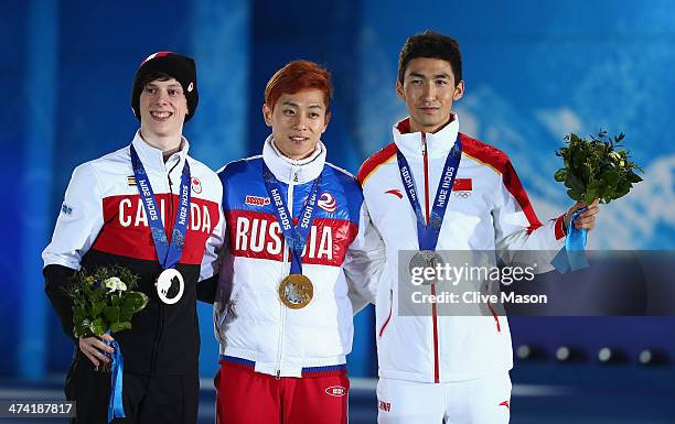 Bronze medalist Charle Cournoyer of Canada, celebrate, gold medalist Victor An of Russia and silver medalist Dajing Wu of China celebrate on the...