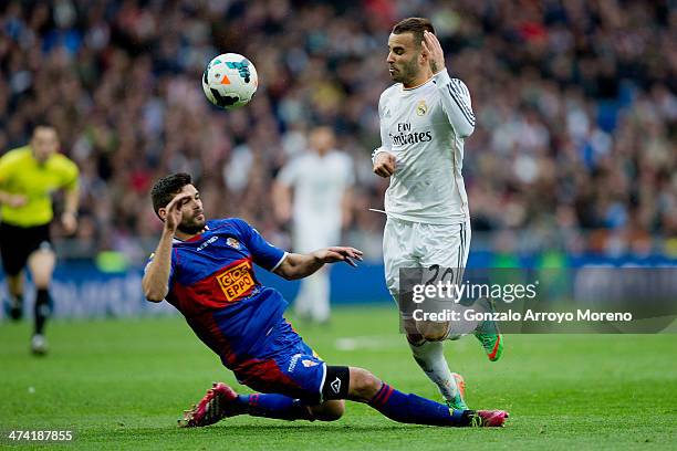 Alberto Tomas Botia of Elche FC tackles Jese Rodriguez of Real Madrid CF during the La Liga match between Real Madrid CF and Elche CF at Estadio...