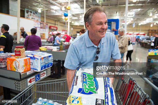 Frank Fiorina, husband of Republican presidential candidate Carly Fiorina, prepares to pay for his items while shopping at a Costco in Woodbridge, VA...