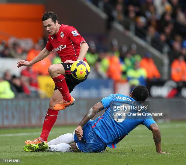 Don Cowie of Cardiff skips the tackle from Hull's Tom Huddlestone during the Barclays Premier League match between Cardiff City and Hull City at...