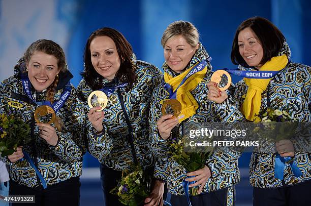Gold medallists Ukraine's Vita Semerenko, Juliya Dzhyma, Valj Semerenko and Olena Pidhrushna pose during the Women's Biathlon 4x6 km Relay Medal...