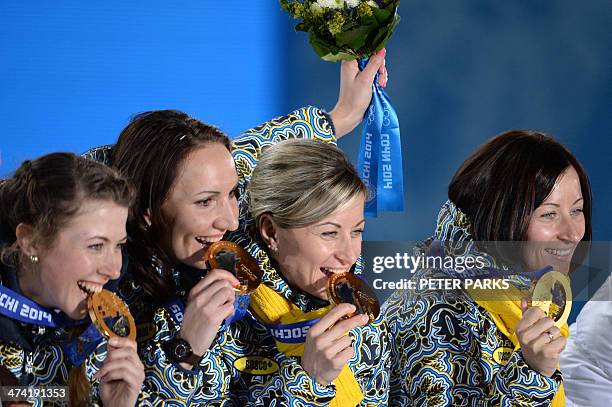 Gold medallists Ukraine's Vita Semerenko, Juliya Dzhyma, Valj Semerenko and Olena Pidhrushna pose with their medals during the Women's Biathlon 4x6...