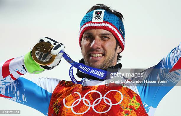 Mario Matt of Austria celebrates on the podium with his gold medal during the medal ceremony for the Men's Slalom during day 15 of the Sochi 2014...