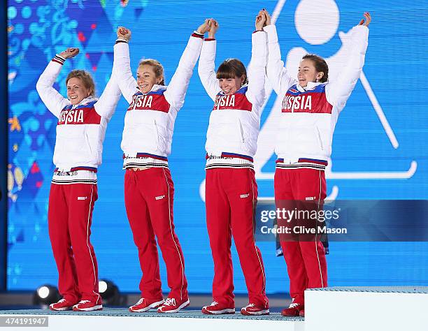 Silver medalists Yana Romanova, Olga Zaitseva, Ekaterina Shumilova and Olga Vilukhina of Russia celebrate during the medal ceremony for the Biathlon...