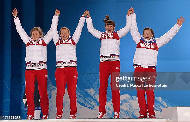 Silver medalists Yana Romanova, Olga Zaitseva, Ekaterina Shumilova and Olga Vilukhina of Russia celebrate during the medal ceremony for the Biathlon...