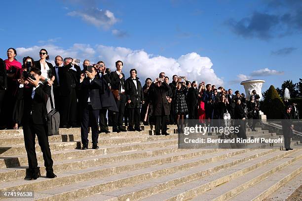 Guests watch an incredible aerial display and fly past by the Patrouille de France in the gardens of the historic Palace of Versailles, ahead of...