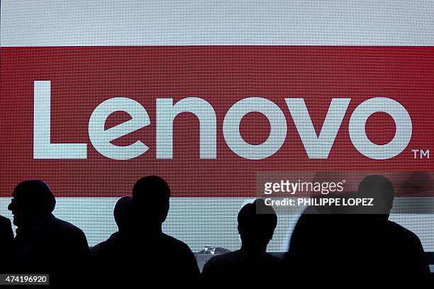The Lenovo's brand logo is displayed on a screen before a press conference in Hong Kong on May 21, 2015. China's Lenovo said its revenue rose 20...