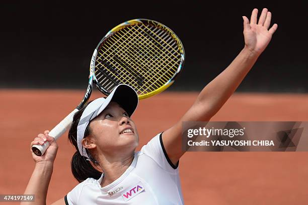 Kurumi Nara of Japan serves the ball to Nastassja Burnett of Italy during their 2014 Rio Open women's semi-final singles tennis match in Rio de...