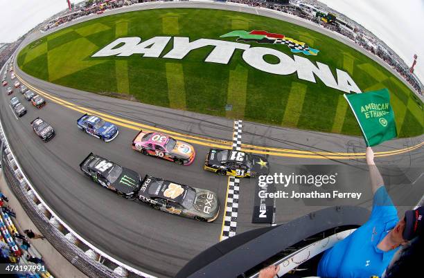 Dylan Kwasniewski, driver of the Rockstar/FOE Chevrolet, and Kyle Larson, driver of the AXE Chevrolet, lead the field past the green flag to start...